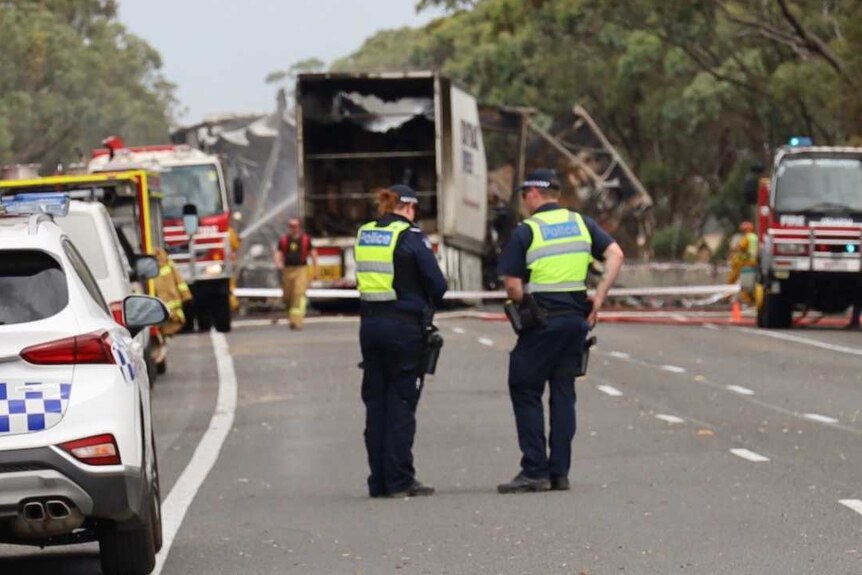 Emergency vehicles surround the wreck of a truck on the Western Highway.
