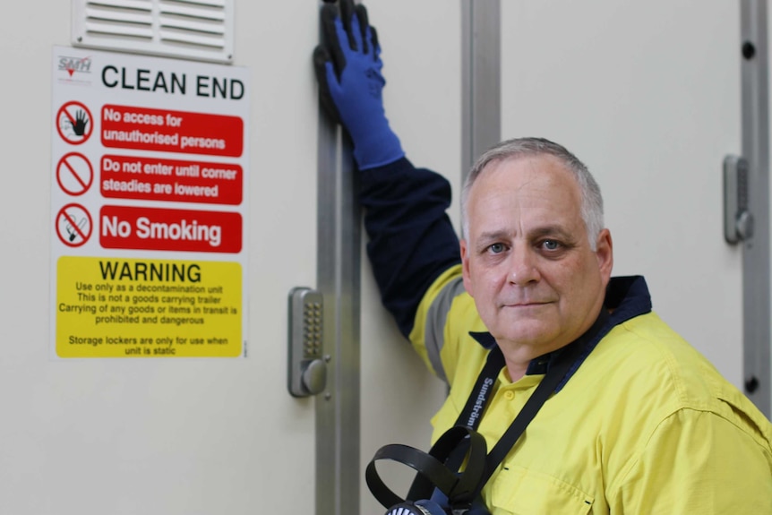 man stands next to sign that says "Clean End" and "no access for unauthorised persons