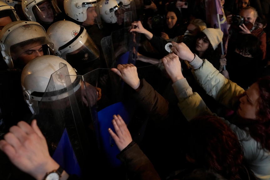 Protesters scuffle with anti riot policemen at the end of the gathering to mark the International Women's Day in Istanbul.