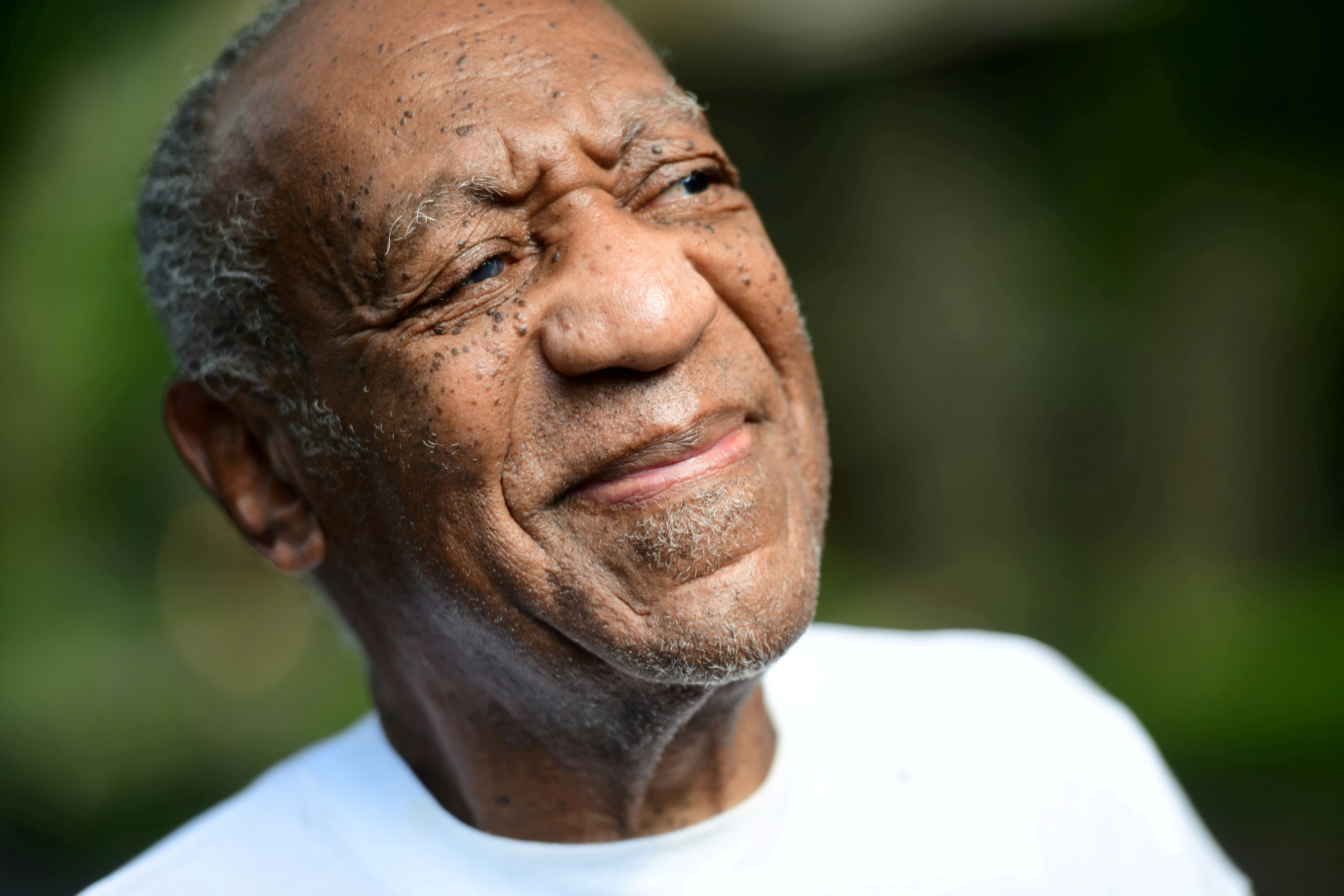 Bill Cosby's face as he looks to the side. 