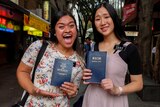 Mormon missionaries Sister Wolfgram and Sister Lu holding The Book of Mormon.