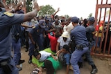 Mourners break through a barrier to try and see Mandela