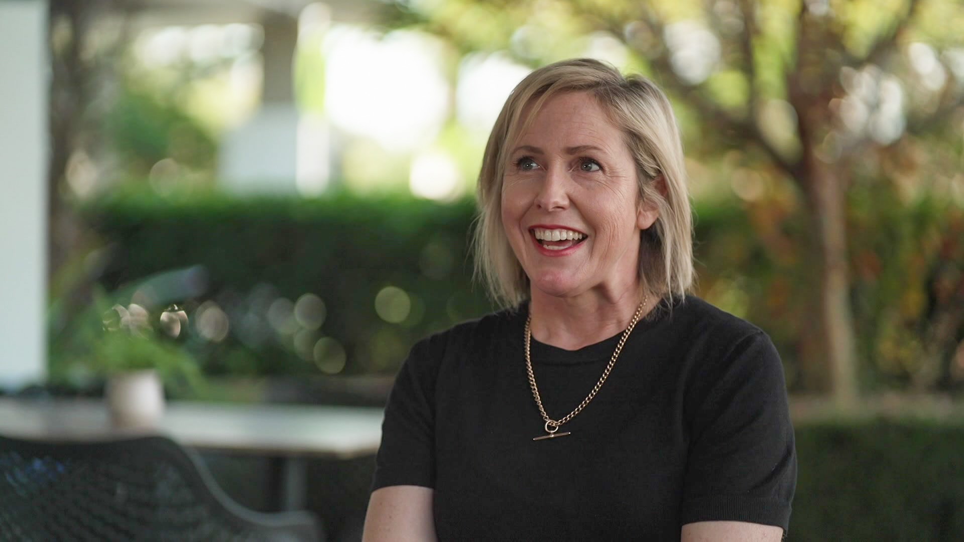 A blonde woman smiling at the camera