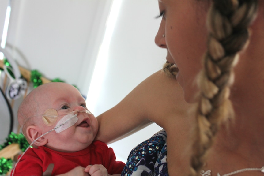 Close up of mum holding a baby and looking into each other's eyes