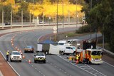 Police and emergency service vehicles and a tent set up on the Mitchell Freeway.