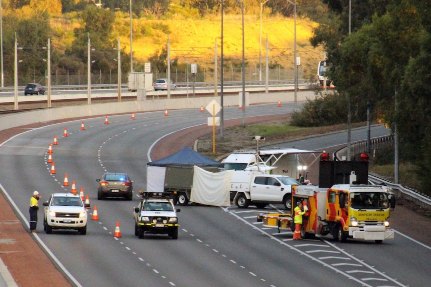 Police and emergency service vehicles and a tent set up on the Mitchell Freeway.