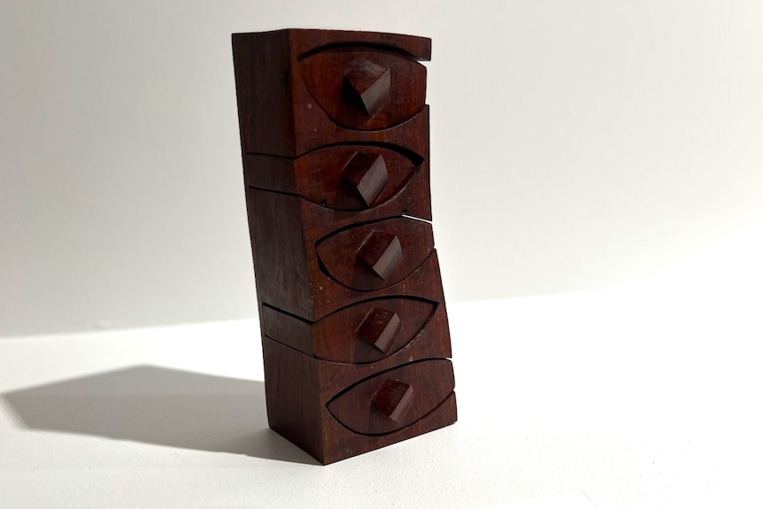 A small intricate tall box made out of redgum