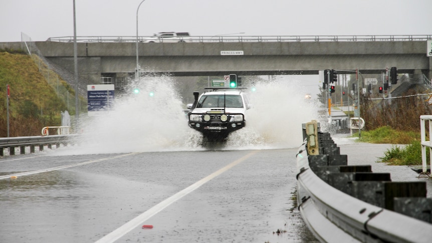 a truck going through a flooded road