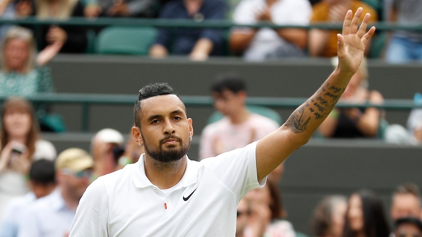 Nick Kyrgios waves to the spectators after losing his match