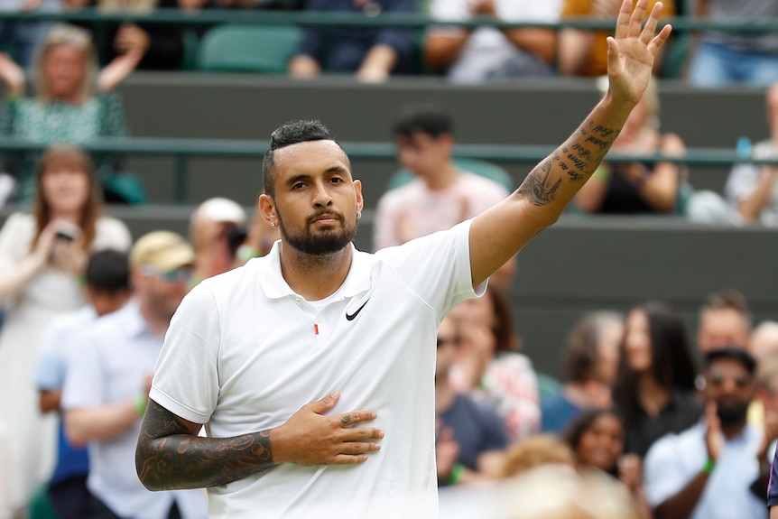 Nick Kyrgios waves to the spectators after losing his match