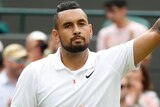 Nick Kyrgios waves to the spectators after losing his match