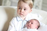 Prince George holds little sister Princess Charlotte