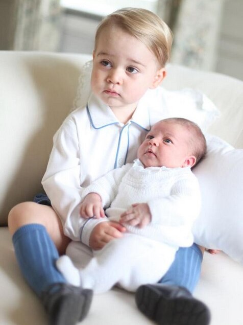 Prince George holds little sister Princess Charlotte