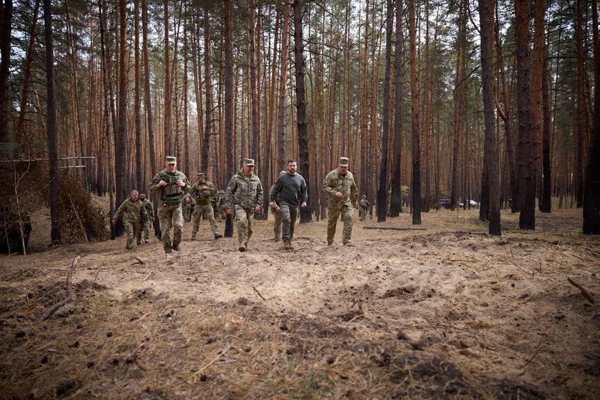 Ukraine's President Volodymyr Zelenskiy with troops on front line. 