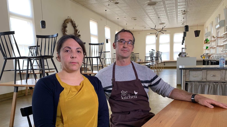 Severine Demanet and Rodney Dunn in empty restaurant.