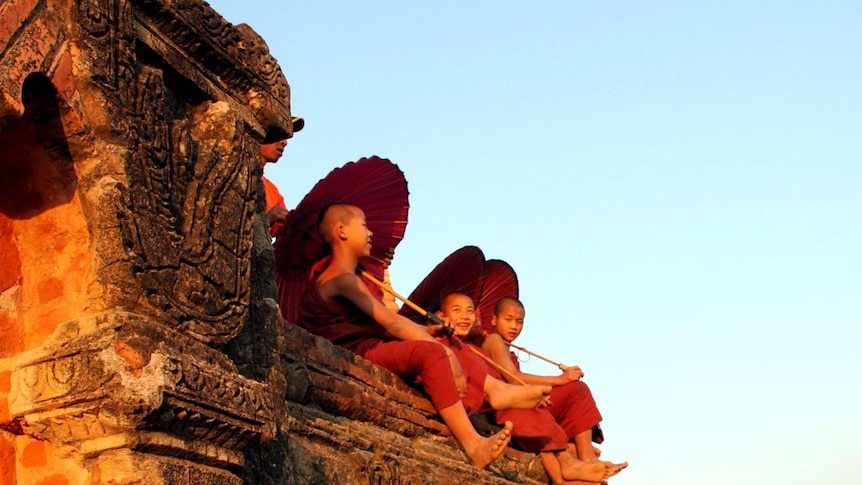 Young monks visit the ancient temples at Bagan in Burma.