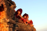 Young monks visit the ancient temples at Bagan in Burma.