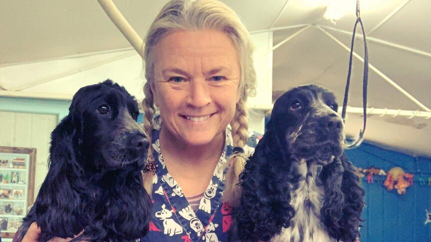 Andi Dolphin poses with two dogs