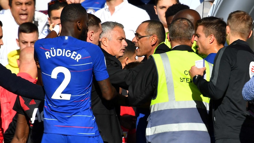 Jose Mourinho is restrained after being involved in a scuffle during the Premier League match between Man United and Chelsea.