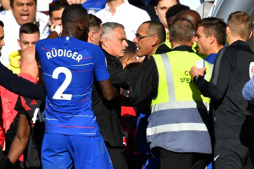 Jose Mourinho is restrained after being involved in a scuffle during the Premier League match between Man United and Chelsea.