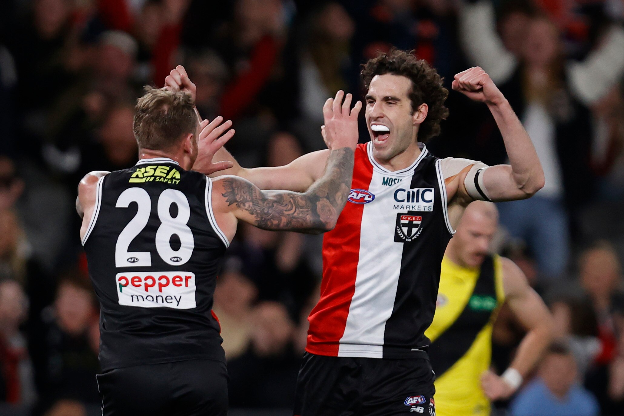 Max King pumps his fists and smiles while running towards a teammate