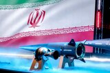 The Iranian flag  is shown with the new hypersonic missile called "fattah'.