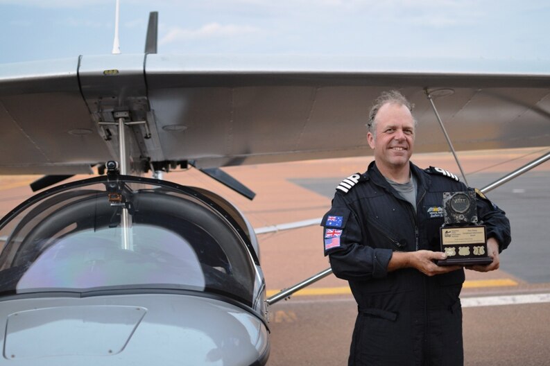 Michael Smith with the trophy presented to him by David Geers from the Seaplane Pilots Association of Australia.