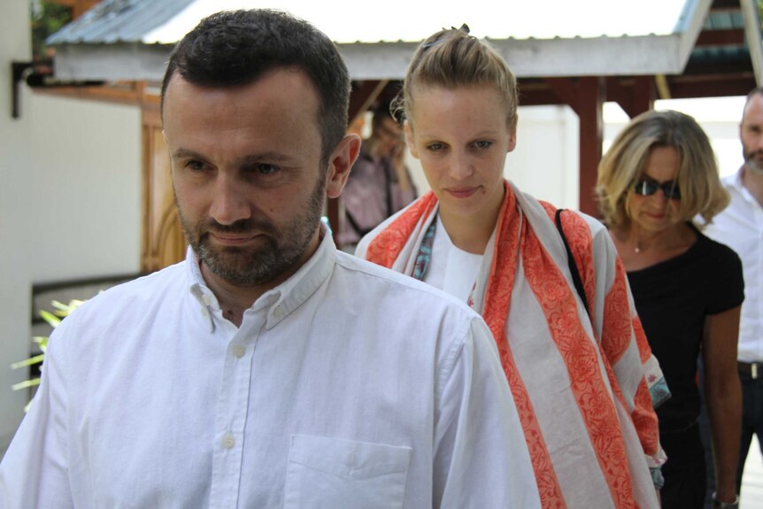 Two French journalists arrive at a court in Indonesia's eastern Papua province