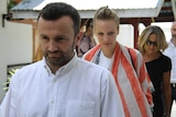 Two French journalists arrive at a court in Indonesia's eastern Papua province