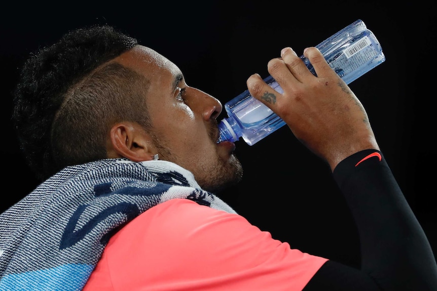 Nick Kyrgios takes a drink from his water bottle during his third-round match at the Australian Open.