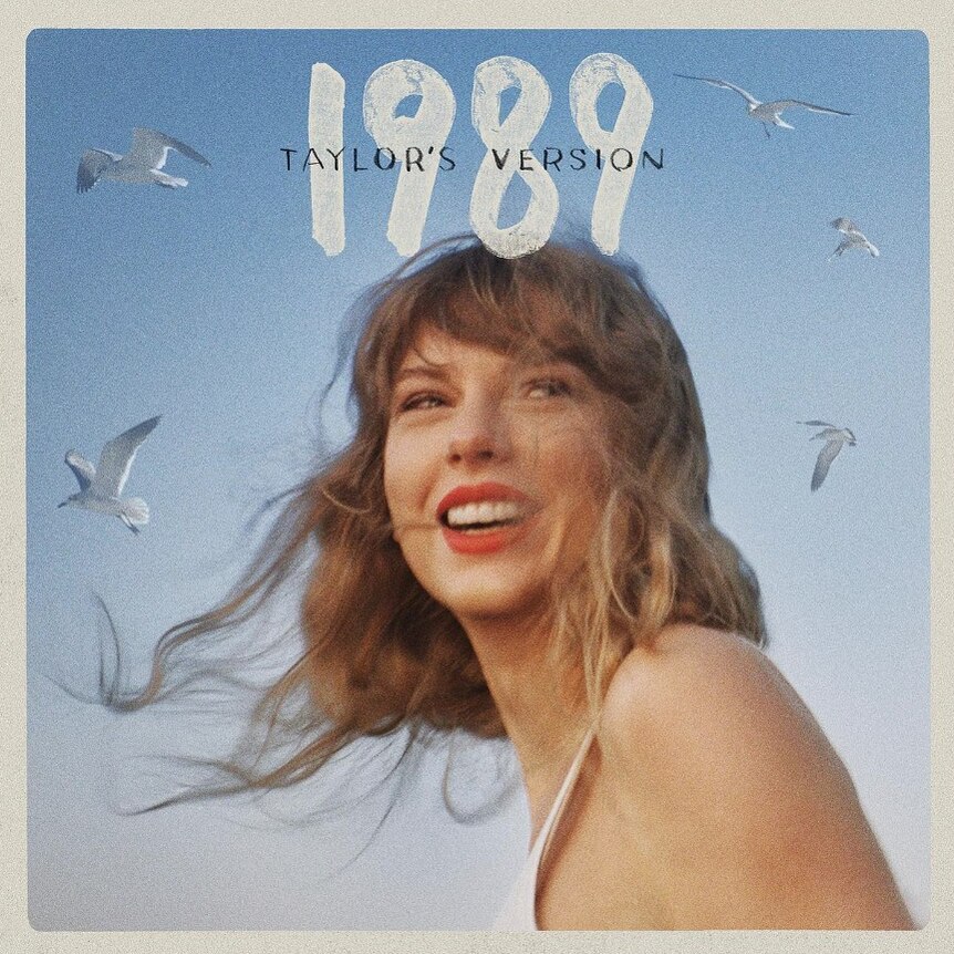 An album cover with a picture of a laughing Taylor Swift on a blue background with the word 1989 Taylor's Version
