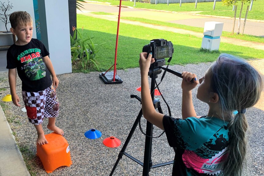 children filming each other outside