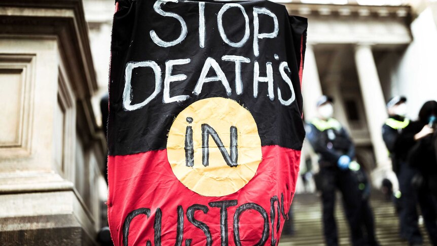 Protesters march in Melbourne to rally against aboriginal deaths in custody in Australia.