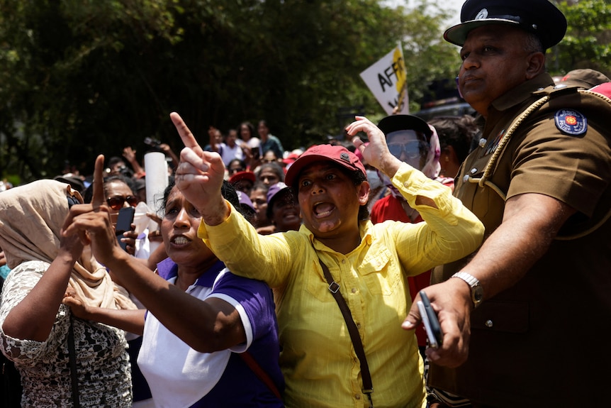 Demonstrators shout at a protest organised by "Women for Rights" group against.