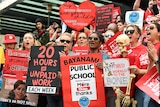 a group of teachers and principals at a rally 