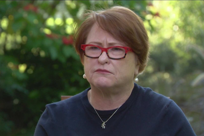 a woman in red framed glasses