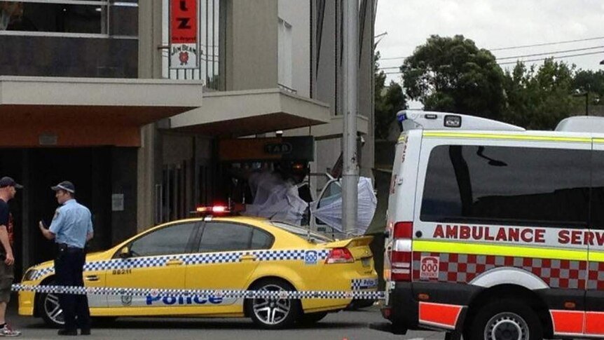 Police and an ambulance park outside a hotel in Redfern, Sydney