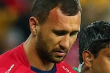 Quade Cooper is helped from the field