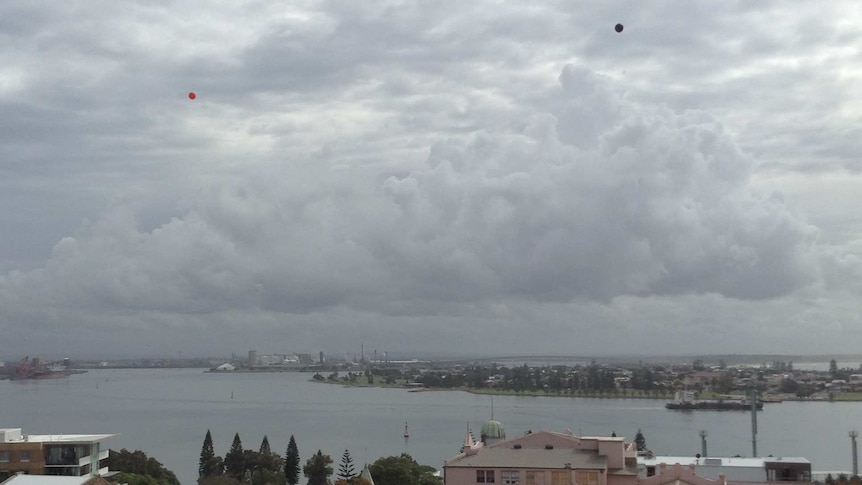 A Newcastle residents group floats balloons over the city's skyline to indicate potential new high-rise building heights.