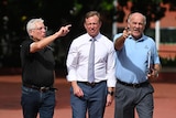 three men walking while pointing in front of suncorp stadium