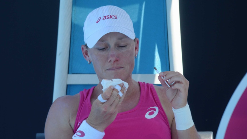 In the wars ... Samantha Stosur treats a bleeding nose before the start of play