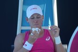 In the wars ... Samantha Stosur treats a bleeding nose before the start of play