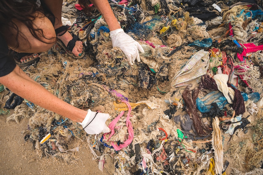 Tangled clothing in the sand.