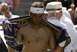 Rafael Nadal towels off during his first Wimbledon match since he won the title in 2008.