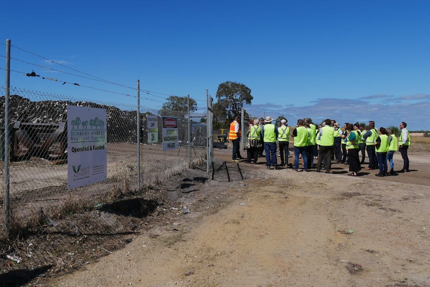 Council workers look at the FOGO system