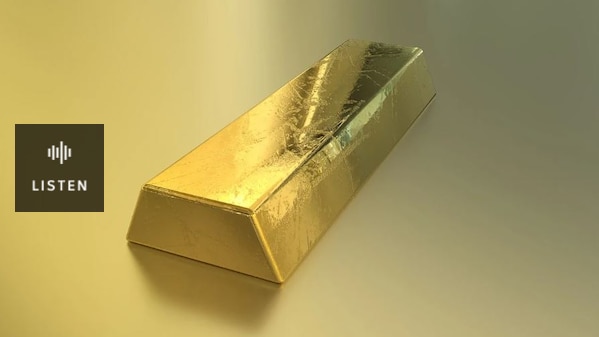Photo of a gold bullion on a yellow background. Has Audio.