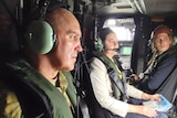 Brigadier Chris Field sits with Premier Annastacia Palaszczuk (centre) in a helicopter