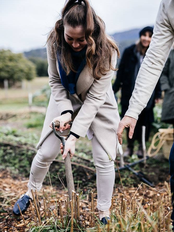 Woman digging at the Agrarian Kitchen Farm in the Derwent Valley.