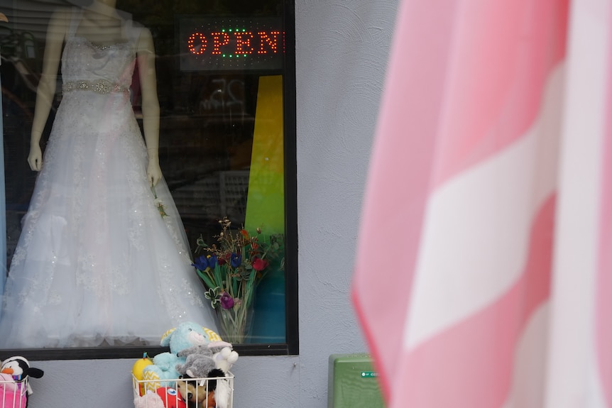 A store font mannequin wearing a wedding dress.