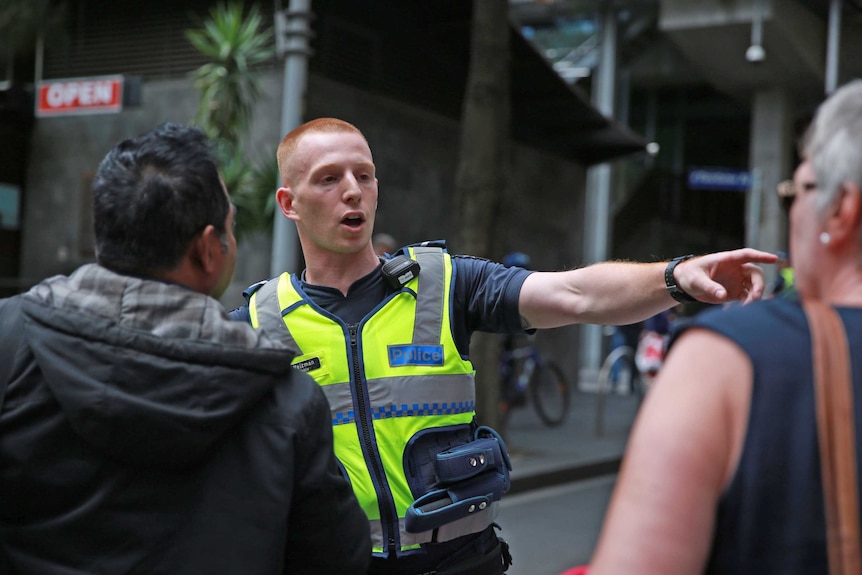 Police direct pedestrians at Little Collins Street